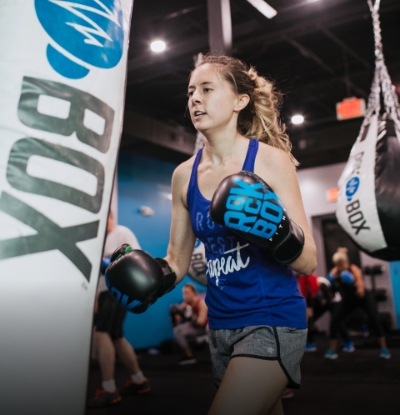 young woman using punching bag